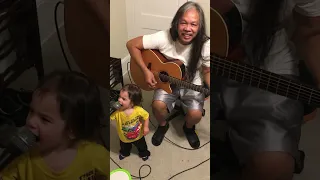 Toddler Sings Along as Grandad Plays the Guitar