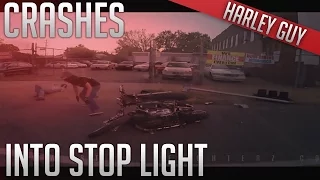 Harley rider crashes into stop light pole on sidewalk !