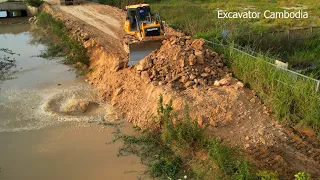 Great Bulldozer Clearing Forest Making Foundation Road And Dump Truck Doing Unload Soil And Stone.