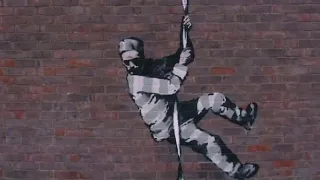 Banksy at work: Black hoodie, head torch, paint and freedom