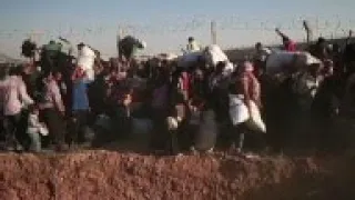 Refugees cross border fence to escape fighting