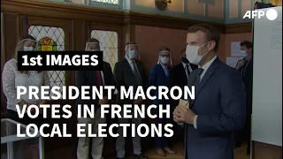 Masked Macron and wife Brigitte vote in French local elections | AFP