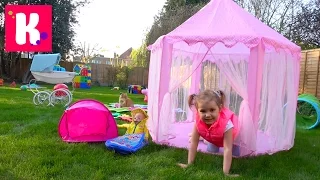 Katy and her picnic with a doll in the yard