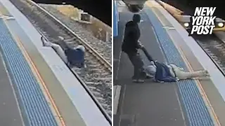 Man pulled from train tracks moments before train pulls in