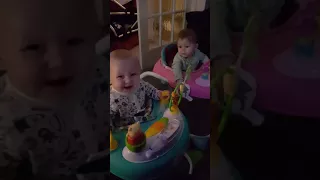 Twins giggling at sneezing