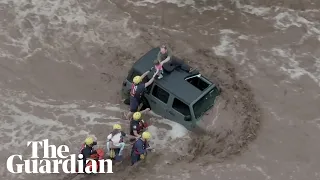 Arizona: stranded family rescued as flash floods inundate cities