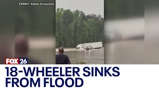 18-wheeler goes off road, submerges during heavy flooding in Houston area