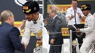 Racing driver Lewis Hamilton soaks Russian President VladimirPutin with champagne