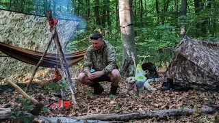 Cooking a leg of lamb on a wooden tripod / pot hanger and hammock and tent camping in the forest.