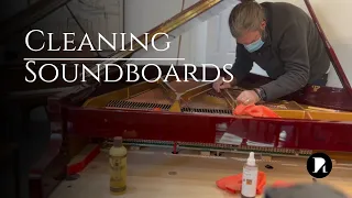 Cleaning under the strings of a grand piano