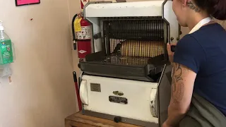 Fresh baked bread sliced on a vintage bread slicer.