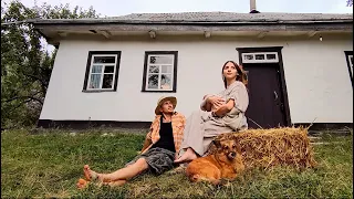 Old traditional house and its new life. Young couple in ukrainian village