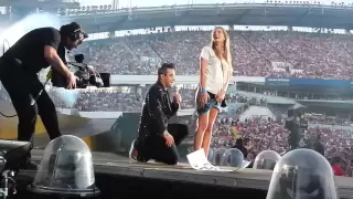 Robbie Williams and a girl on stage