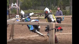 Armored knights in an Axe fight at the Texas Renaissance Festival ends with pommel strike