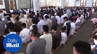Muslims attend morning prayers to celebrate first day of Eid al-Fitr