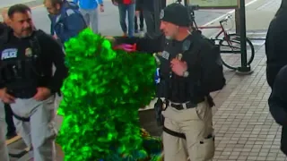 BUSHMAN SCARE PRANK ATTACKED BY A POLICE OFFICER