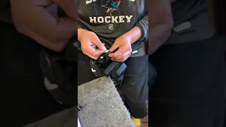 Handstitching small tears on player glove fingers