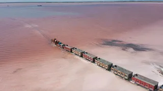 Train Travels Across Stunning Pink Salt Lake