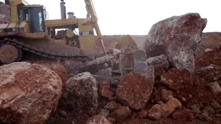 Caterpillar D11R pushing a massive rock 1