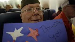 World War II veterans open surprise thank you letters on their Honor Flight trip