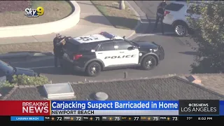 Police still engaged in standoff with armed carjacking suspect in Newport Beach