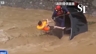 [WATCH] Stranded driver abseils to safety in China's raging floodwaters