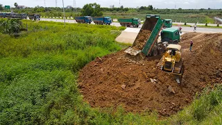 Excellent Competence Komatsu D51P Bulldozer Pushing Soil, Dump Truck Transport Soil The Land Filling