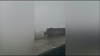 VIDEO: Two men help rescue UPS driver from overturned truck during severe storm
