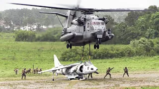 U.S. Marines lifting AV-8B Harrier II jet with CH-53E Super Stallion