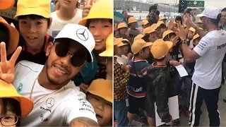F1 star Lewis Hamilton mobbed by young fans in Japan