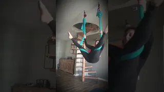 Aerial yoga trick from key straddle