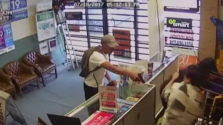 Shocking CCTV shows men fight off armed robbers barehanded