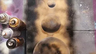 Black and gold spray paint planets