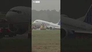 Plane veers off runway and gets stuck in grass at Houston airport