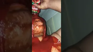 Guy pours tomato sauce on himself