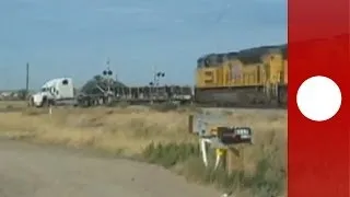 Dramatic footage: Train hits trailer truck stuck on tracks, 'Holy smokes'! says witness