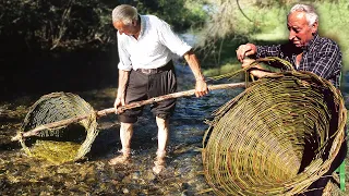 Ancestral fishing basket made of wicker. Braided by an expert basket maker and its use in the river
