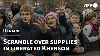 Ukrainians scramble over aid supplies in liberated Kherson | AFP