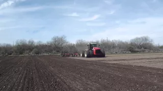 Versatile 550 Tractor pulling a 56' Farm King Chisel Plow near Castroville Texas