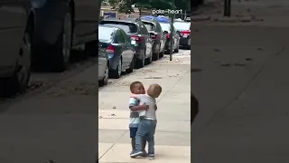 Two Toddlers Adorably Hug Each Other While Running on Street