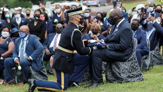 Flag removed from John Lewis' casket, presented to family at cemetery