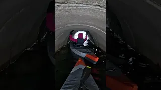 Goin under a road in a tunnel to a lake. Kayaking paddle life.
