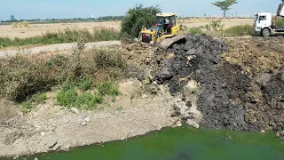 Heavy Shantui Bulldozer Working And Dongfeng Dump Trucks Unloading Dirt Mud Land Filling Up In Water