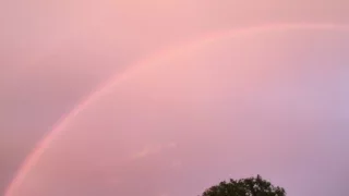 Double rainbow appears in pink sky after thunderstorm