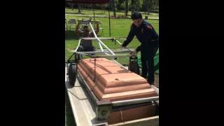 Lifting the top of the burial vault