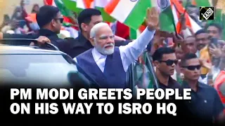 PM Modi greets people on his way to ISRO Mission Control Complex in Bengaluru to meet Scientists