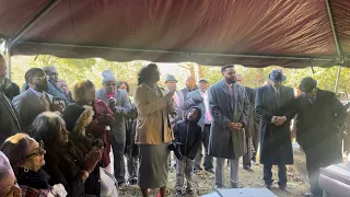 Family singing at Momo’s Graveside  “Sit Down Servant”