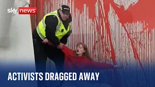 Climate activists dragged away by police after throwing paint at Scottish Parliament