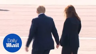 Donald Trump and Melania hold hands before boarding Marine One