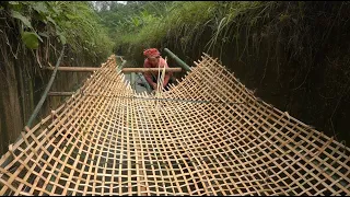 The Couple Weaves Bamboo Nets To Catch Fish. Peaceful Life Near The Green Forest